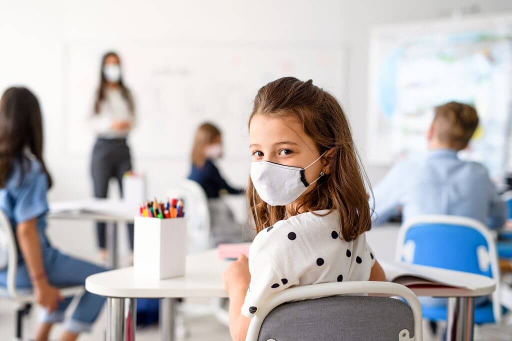 child-with-face-mask-back-at-school-after-covid-19